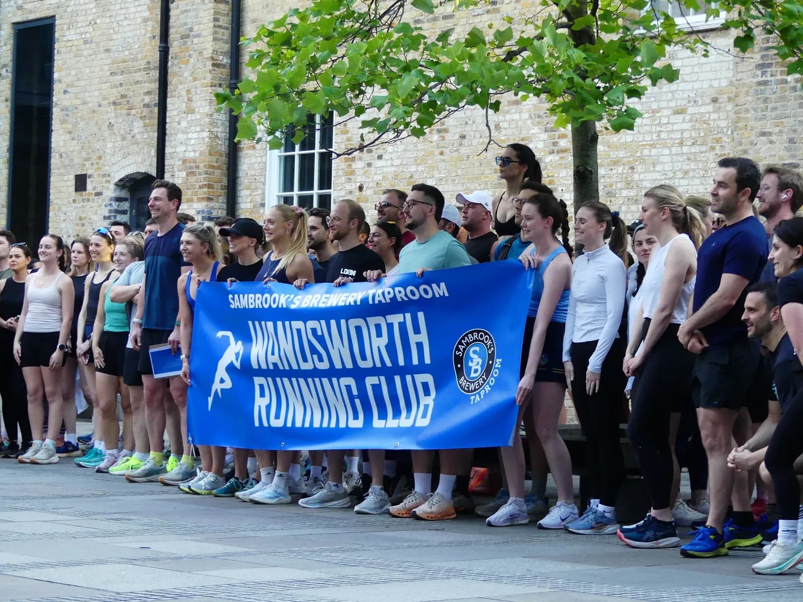 A large running club group gathered before a run